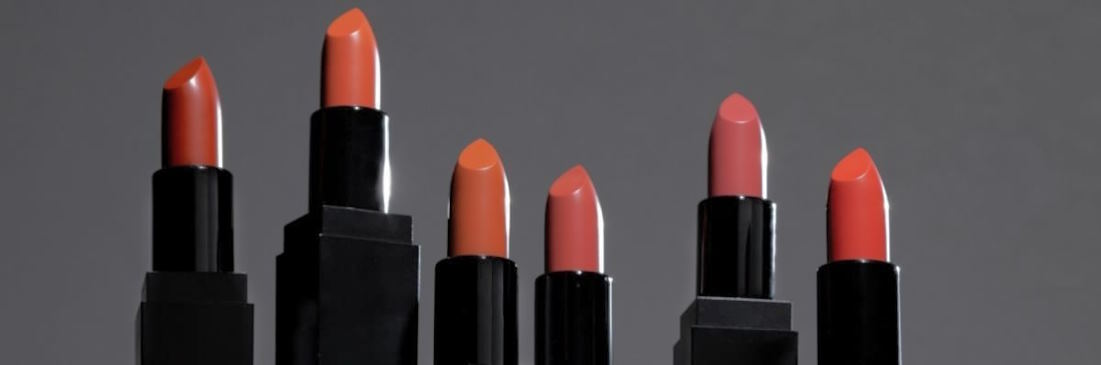 applying several lipsticks